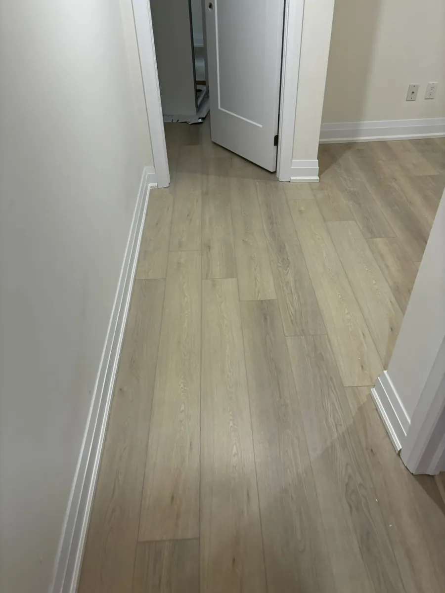 Light wood-look luxury vinyl tile (LVT) installed in a commercial office space by Geometrix Flooring & Design