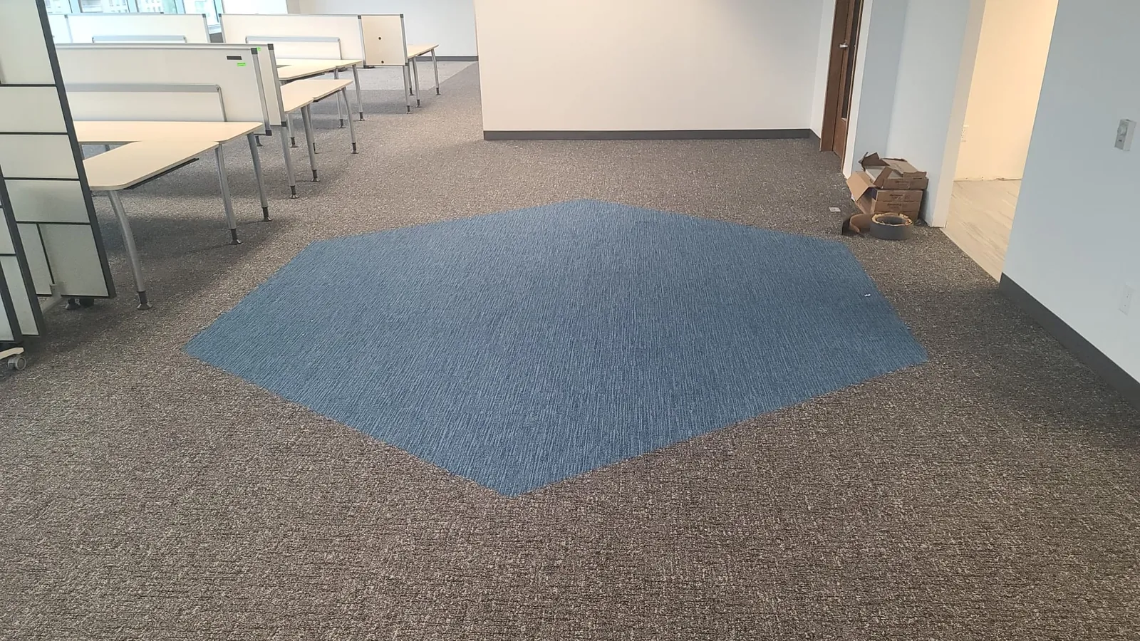 Modern open-plan commercial office with a custom carpet-tile inlay installed by Geometrix Flooring & Design